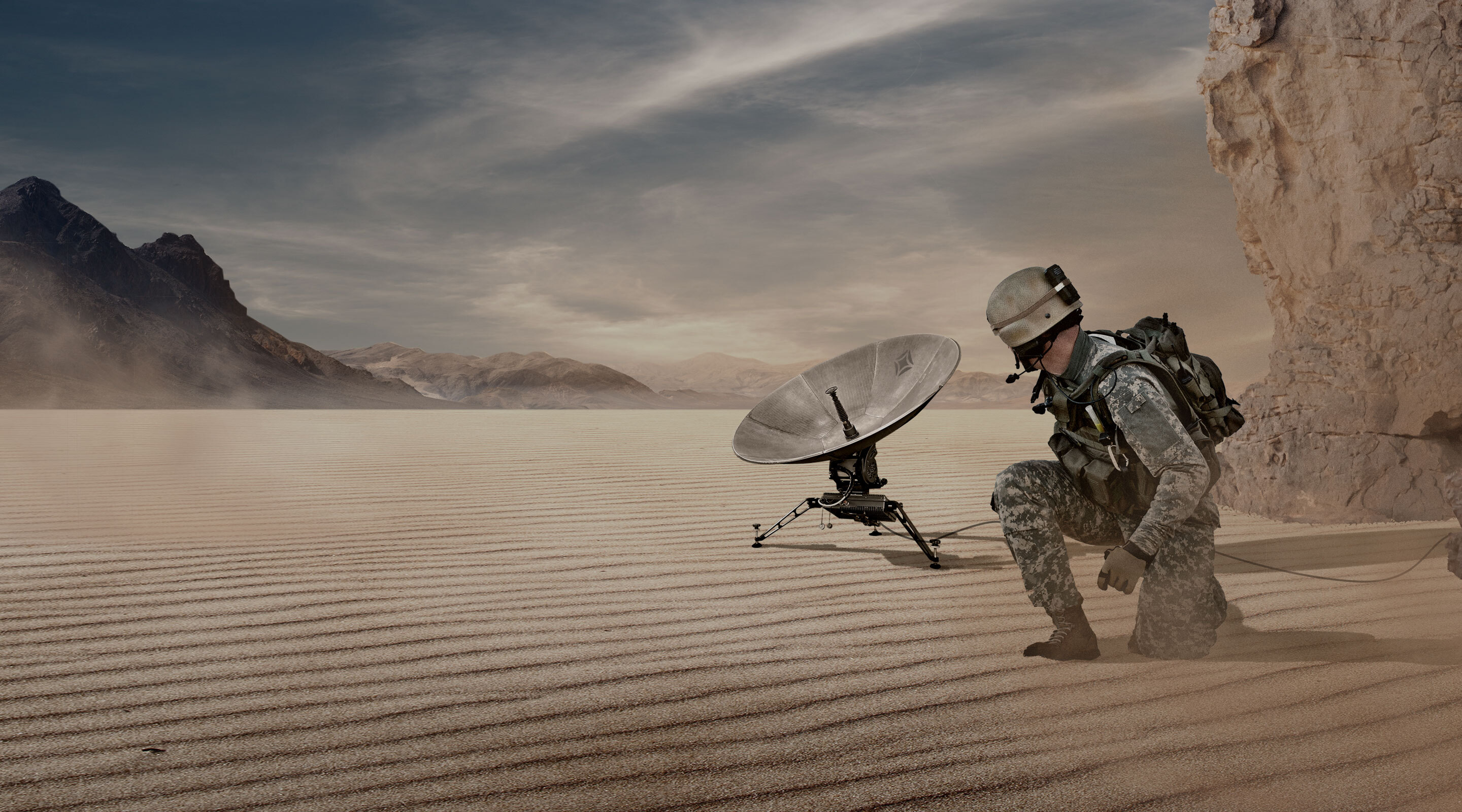 soldier in a desert with a satellite dish