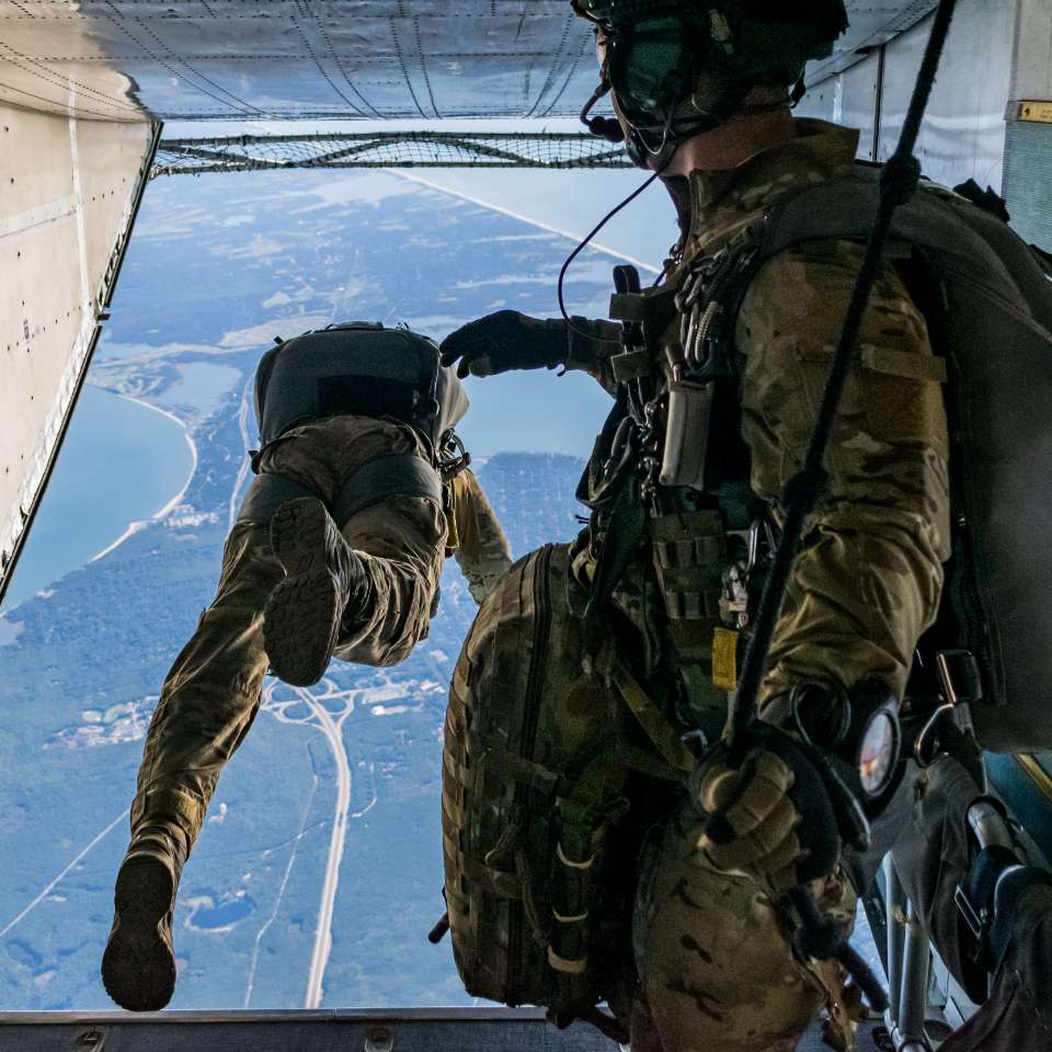 soldier jumping out of a plane